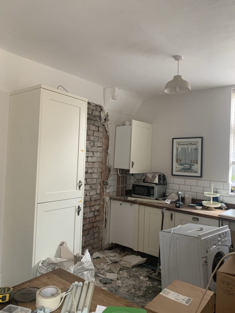 Before photo of kitchen during renovation. Walls to be demolished and cabinets being ripped out