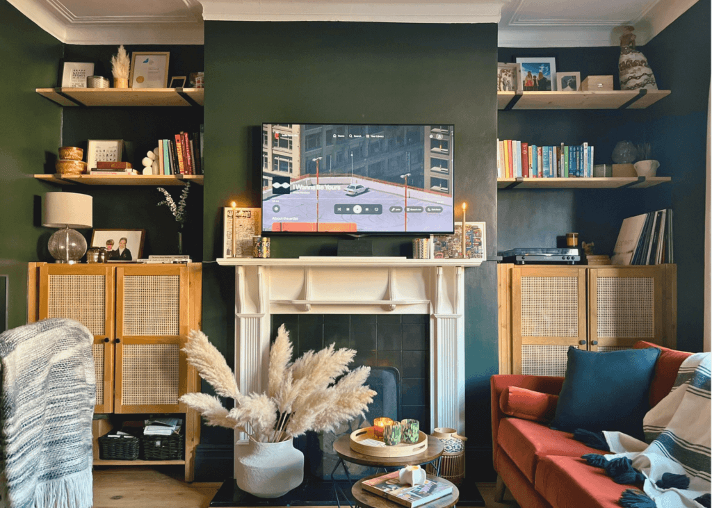 cover Image of a transformed living room into a multi-functional home office with dark green walls and a workspace