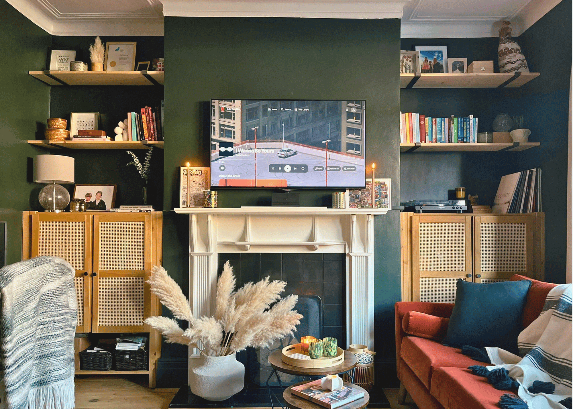 Boho industrial living room in Chorlton with bespoke joinery, green feature wall, and layered textures – full-service interior design by Spaces by Kelly. Showcasing Full-service interior design services